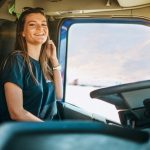 Portrait,Of,Beautiful,Young,Woman,Professional,Truck,Driver,Sitting,In