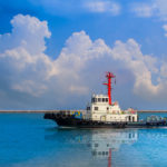 Tug,Boat,Run,In,Sea,On,Sky,Blue,Background