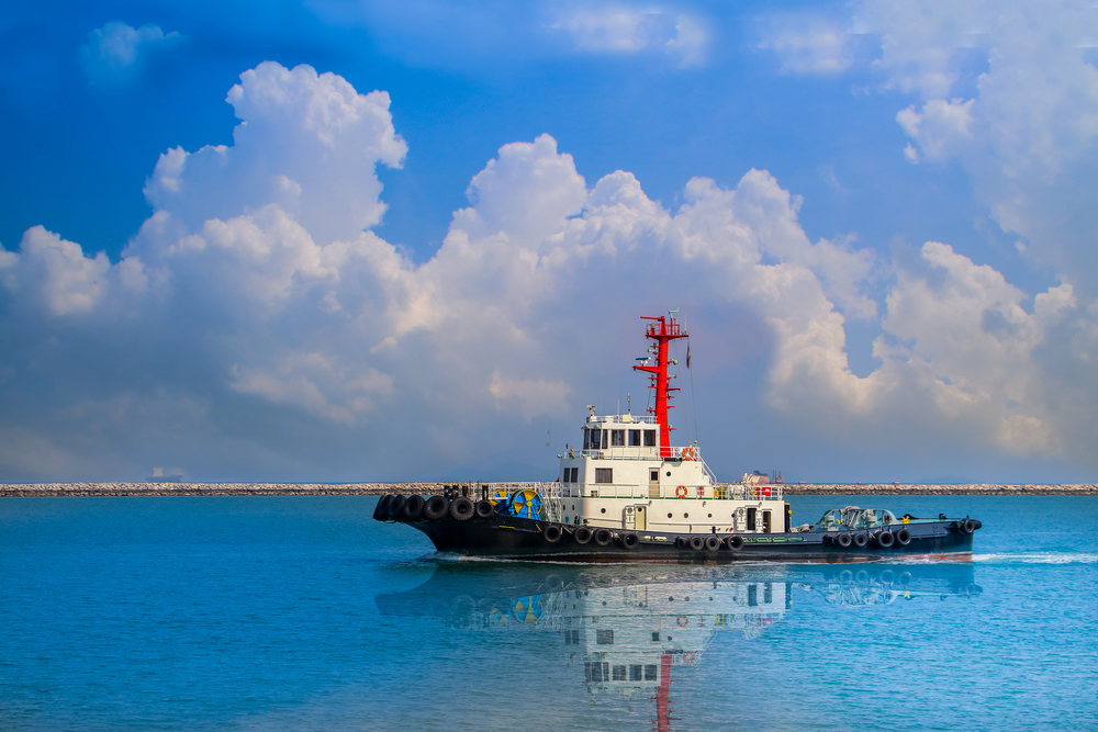 Tug,Boat,Run,In,Sea,On,Sky,Blue,Background